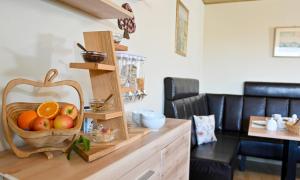 a kitchen with a basket of fruit on a counter at Pension Schöpke in Bad Staffelstein