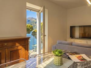 a living room with a couch and a glass table at Apartment Tinca by Interhome in Domaso