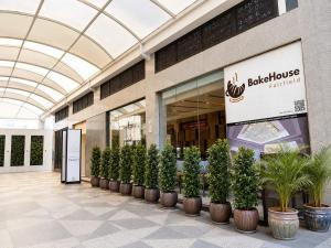a building with a row of potted plants in front at Fairfield by Marriott Agra in Agra