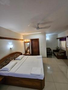 a bedroom with a large bed in a room at Hotel Gazala in Palakkad