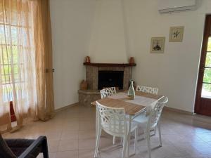 a dining room with a table and chairs and a fireplace at Villa Filomena in Montoro Inferiore