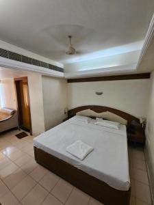 a bedroom with a large bed in a room at Hotel Gazala in Palakkad