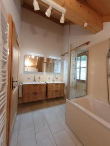 a large bathroom with a tub and a sink at Almchalet Schweigerbuam Lachtal in Hinteralm