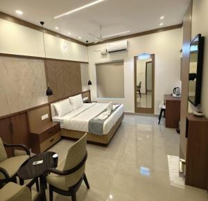 a hotel room with a bed and a living room at AdaraResidency in Trivandrum
