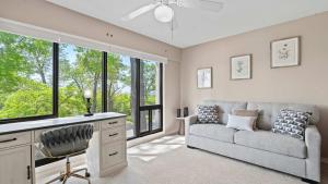 a living room with a couch and a chair at Lake Ozark Oasis Central Location & Pool Access in Lake Ozark