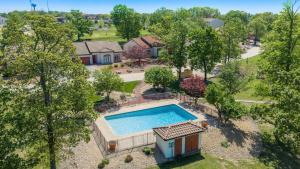 an overhead view of a swimming pool in a yard at Lake Ozark Oasis Central Location & Pool Access in Lake Ozark