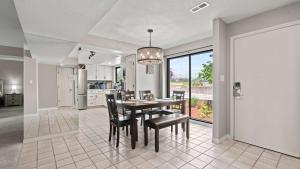 a kitchen and dining room with a table and chairs at Lake Ozark Oasis Central Location & Pool Access in Lake Ozark