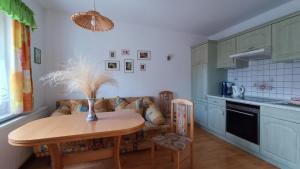 a kitchen with a table and a couch at Ferienhaus "Morgensonne" in Kurort Gohrisch