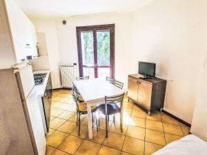 a kitchen with a table and chairs in a room at Apartment Mairen-3 by Interhome in Rosolina Mare