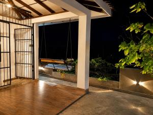 an open porch with a swing at night at Sunrise Eco Resort in Matara