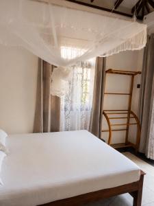 a bedroom with a white bed with a canopy at Sunrise Eco Resort in Matara +27 photos