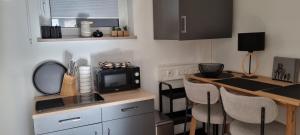 a small kitchen with a table and two chairs at zeitlang by angelika kodewitz in Waldsassen +21 photos
