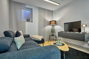 a living room with a couch and a tv at zeitlang by angelika kodewitz in Waldsassen