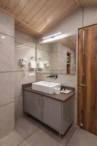 a bathroom with a sink and a mirror at Regal Retreat Inn in Shirir +86 photos