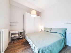 a white bedroom with a bed and a night stand at Apartment Studio Kalè Akté by Interhome in Caronia +11 photos
