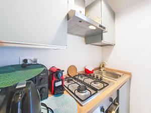 a small kitchen with a stove and a sink at Apartment Studio Kalè Akté by Interhome in Caronia