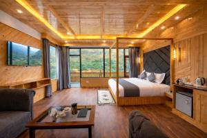 a bedroom with a bed and a couch and a table at Regal Retreat Inn in Shirir