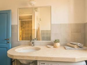 a bathroom with a sink and a mirror at Apartment Nuraghi by Interhome in Arzachena
