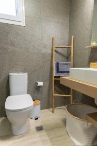 a bathroom with a toilet and a sink at Mea Casa Comfort Home in Pitsidia +81 photos