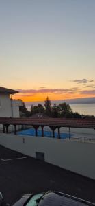 a view of the ocean at sunset from a building at Appartement T2 lac Léman in Publier