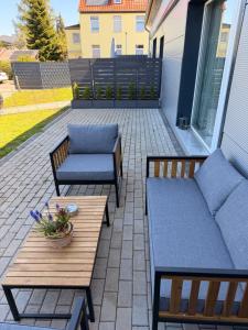 a patio with two couches and a table at SleepShop in Nordhausen