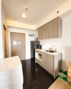 a kitchen with a sink and a refrigerator at Lucky 98 Sky Stay in Bang Phli