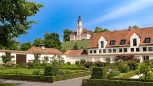 an estate with a garden and a castle in the background at Bodensee-Schloss Maurach in Uhldingen-Mühlhofen