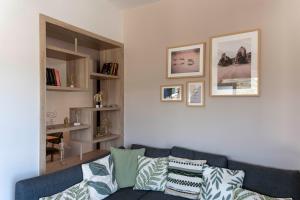 a living room with a blue couch with pillows at Mea Casa Comfort Home in Pitsidia