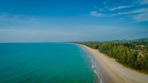 an aerial view of a sandy beach and water at OUTRIGGER Khao Lak Beach Resort in Khao Lak