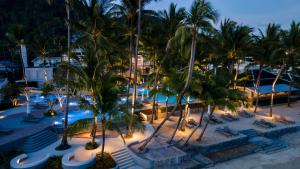 an aerial view of a resort pool at night at OUTRIGGER Koh Samui Beach Resort in Lamai