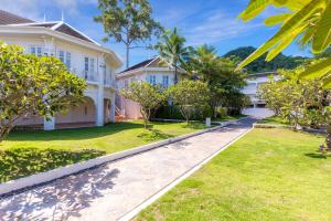 an exterior view of a house with a yard at OUTRIGGER Koh Samui Beach Resort in Lamai