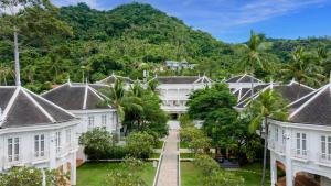 a view of the courtyard of a resort with palm trees at OUTRIGGER Koh Samui Beach Resort in Lamai +71 photos