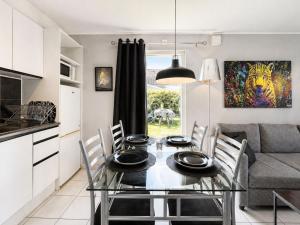 a kitchen and dining room with a glass table and chairs at Apartment Brömsebro by Interhome in Halmstad