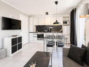a kitchen and living room with a table and chairs at Apartment Brömsebro by Interhome in Halmstad +9 photos