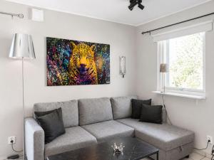 a living room with a tiger painting on the wall at Apartment Brömsebro by Interhome in Halmstad
