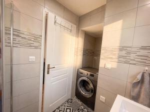 a bathroom with a washing machine and a washer at L'Écrin Beige - Moderne - Portes de Strasbourg in Schiltigheim +17 photos