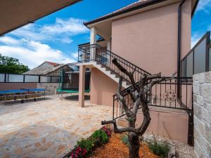 a building with a staircase and a playground at Holiday Home Šimić by Interhome in Dušić +38 photos