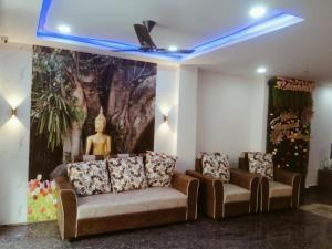 a room with two couches and a painting on the wall at HOTEL TIRUMALA VAIBHAv in Secunderabad