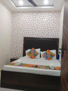 a bed with two pillows on it in a room at HOTEL TIRUMALA VAIBHAv in Secunderabad