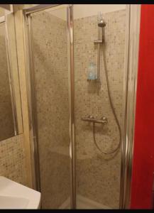 a shower with a glass door in a bathroom at Dimora Victoria in Ascoli Piceno