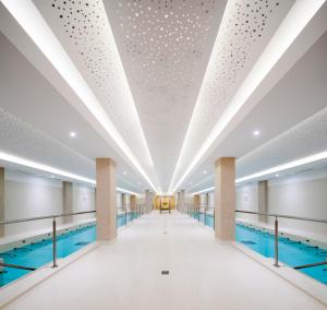 a swimming pool with a ceiling with lights at Résidences LES HAUTES PLAINES in Gréoux-les-Bains