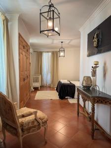 a living room with a table and a chair at Villa Reis - Boutique House in Golegã