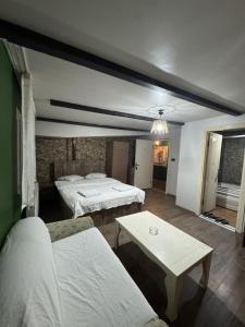 a hotel room with two beds and a table at Cağaloğlu Apart Butik Otel in Atakum +31 photos