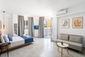 a hotel room with a bed and a couch at Faflagos Apartments in Psari Forada