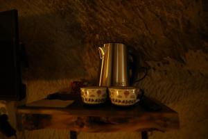 a coffee maker and two cups on a table at Rock Mansion Cappadocia in Nar