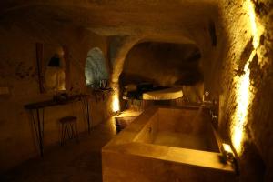 a bathroom with a bath tub in a cave at Rock Mansion Cappadocia in Nar +62 photos