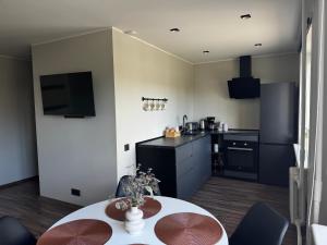 a kitchen with a table and a kitchen with a counter at Karusselli beach home, free parking in Pärnu