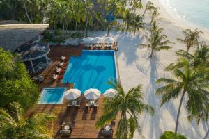 an overhead view of a resort swimming pool and the beach at OUTRIGGER Maldives Maafushivaru Resort in Dhangethi