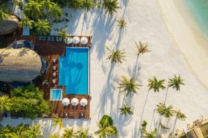 an overhead view of a resort on a beach at OUTRIGGER Maldives Maafushivaru Resort in Dhangethi +195 photos
