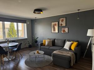 a living room with a couch and a table at Karusselli beach home, free parking in Pärnu +1 photo